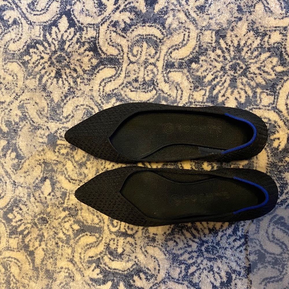 Rothy’s black pattern pointed toe shoes.